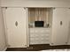 Bedroom closet with built in dresser and hanging space, closed by two sliding doors at 3318 Oakwood S Blvd, Sarasota, FL 34237