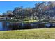 Scenic community with lake views, lush landscaping and gazebo on a bright day at 3318 Oakwood S Blvd, Sarasota, FL 34237