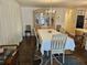 Traditional dining room with a table covered by white tablecloth and a decorative chandelier at 3318 Oakwood S Blvd, Sarasota, FL 34237