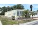 Well-maintained single-story home featuring tidy landscaping, window awnings, and a peaceful neighborhood setting at 3318 Oakwood S Blvd, Sarasota, FL 34237