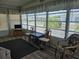 Bright and open sunroom featuring large windows and a view of the community at 3318 Oakwood S Blvd, Sarasota, FL 34237