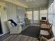 Cozy sunroom featuring natural light, neutral decor, and a comfortable seating area at 3318 Oakwood S Blvd, Sarasota, FL 34237