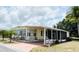 Inviting single-story home boasting a covered carport, mature landscaping, and a tidy exterior at 3318 Oakwood S Blvd, Sarasota, FL 34237