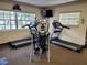 Fitness center featuring treadmills and elliptical machines with mounted television for entertainment at 3318 Oakwood S Blvd, Sarasota, FL 34237