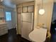 Kitchen with white cabinets and appliances, dark floors, and white walls at 3318 Oakwood S Blvd, Sarasota, FL 34237
