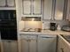 Practical kitchen design featuring a dishwasher, classic cabinetry, and essential cooking appliances at 3318 Oakwood S Blvd, Sarasota, FL 34237