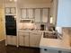 Functional kitchen with vintage appliances, wood cabinets, and laminate countertops at 3318 Oakwood S Blvd, Sarasota, FL 34237