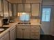 Cozy kitchen with ample counter space, neutral cabinets, and essential appliances at 3318 Oakwood S Blvd, Sarasota, FL 34237