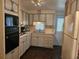 Efficient kitchen featuring a dishwasher, oven, updated cabinets, and practical design at 3318 Oakwood S Blvd, Sarasota, FL 34237