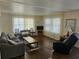 Inviting living room featuring wood flooring, natural light, and comfortable furniture at 3318 Oakwood S Blvd, Sarasota, FL 34237
