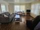 Cozy living room with a comfortable sofa, wood flooring, and lots of natural light at 3318 Oakwood S Blvd, Sarasota, FL 34237