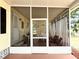Large screened porch featuring multiple seating areas at 3318 Oakwood S Blvd, Sarasota, FL 34237
