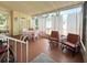 Relaxing sun room featuring tile floor, large windows, and comfortable seating at 3318 Oakwood S Blvd, Sarasota, FL 34237