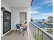Cozy balcony with seating area overlooking the waterfront and boat docks at 3320 Gulf Of Mexico Dr # 208C, Longboat Key, FL 34228