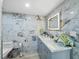 Elegant bathroom featuring marble countertops, a modern lighted mirror, and stylish decor at 3320 Gulf Of Mexico Dr # 208C, Longboat Key, FL 34228