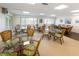 The dining room features multiple tables and chairs, bright lighting, and serene artwork at 3320 Gulf Of Mexico Dr # 208C, Longboat Key, FL 34228