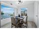Bright dining room features a water view and a wood table with four chairs at 3320 Gulf Of Mexico Dr # 208C, Longboat Key, FL 34228