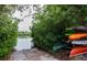 Kayaks sit by the water, surrounded by green trees, offering an invitation to aquatic adventures at 3320 Gulf Of Mexico Dr # 208C, Longboat Key, FL 34228