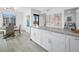 Bright kitchen features a breakfast bar, marine artwork, and an adjacent dining area, perfect for entertaining at 3320 Gulf Of Mexico Dr # 208C, Longboat Key, FL 34228