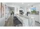 Modern kitchen boasts a large marble island, stainless steel appliances, and sleek white cabinetry at 3320 Gulf Of Mexico Dr # 208C, Longboat Key, FL 34228
