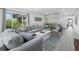 Bright living room features large windows, comfortable seating, and stylish decor for a relaxing atmosphere at 3320 Gulf Of Mexico Dr # 208C, Longboat Key, FL 34228