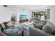 Bright living room boasts comfortable seating, TV, and decor at 3320 Gulf Of Mexico Dr # 208C, Longboat Key, FL 34228