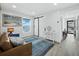 Coastal living room with a comfortable couch, stylish rug, and water views at 3320 Gulf Of Mexico Dr # 208C, Longboat Key, FL 34228