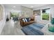 Open concept living room with comfortable seating, natural light, and stylish decor at 3320 Gulf Of Mexico Dr # 208C, Longboat Key, FL 34228