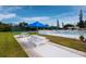 A well-kept pool area features a pristine pool, crisp white lounge furniture, and manicured greenery at 3320 Gulf Of Mexico Dr # 208C, Longboat Key, FL 34228