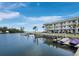 Scenic waterfront view featuring docks, boats, and a condominium complex with a coastal vibe at 3320 Gulf Of Mexico Dr # 208C, Longboat Key, FL 34228