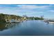 Picturesque waterfront showcasing docks and boats surrounded by lush greenery under a blue sky at 3320 Gulf Of Mexico Dr # 208C, Longboat Key, FL 34228