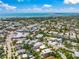 Wide aerial shot of a coastal community boasting a mix of housing and shops near a beautiful ocean and lake at 340 Avenida De Mayo, Sarasota, FL 34242