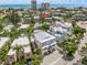 Aerial view of the home among similar buildings with a garage and balconies near the beach and gulf at 340 Avenida De Mayo, Sarasota, FL 34242