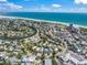 Panoramic aerial view capturing the neighborhood's charm, winding waterways, and the adjacent beachfront at 340 Avenida De Mayo, Sarasota, FL 34242