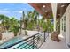 Inviting balcony overlooking a pool and lush tropical landscaping at 340 Avenida De Mayo, Sarasota, FL 34242