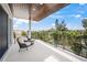 Relaxing balcony with seating, a wood-paneled ceiling, and lush treetop views at 340 Avenida De Mayo, Sarasota, FL 34242