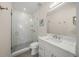 Modern bathroom with white tiles, glass shower and vanity with quartz countertop at 340 Avenida De Mayo, Sarasota, FL 34242