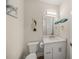 Charming powder room with nautical-themed decor, a white vanity and a toilet at 340 Avenida De Mayo, Sarasota, FL 34242