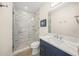 Bathroom featuring marble shower, quartz countertop and navy blue cabinets at 340 Avenida De Mayo, Sarasota, FL 34242
