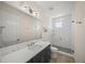 Stylish bathroom with a frameless glass shower, modern vanity, and ample lighting at 340 Avenida De Mayo, Sarasota, FL 34242