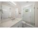 Bright bathroom with white vanity, quartz countertop and frameless glass shower at 340 Avenida De Mayo, Sarasota, FL 34242