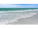 Waves gently rolling onto the sandy shore on a bright day at 340 Avenida De Mayo, Sarasota, FL 34242