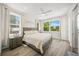 Bedroom with three windows letting in natural light, plank floors and ceiling fan at 340 Avenida De Mayo, Sarasota, FL 34242