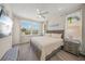 Bright bedroom with a large bed, neutral colors, plank floors and three windows at 340 Avenida De Mayo, Sarasota, FL 34242