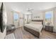 Bright bedroom with a king-size bed, three windows, and wood-look flooring at 340 Avenida De Mayo, Sarasota, FL 34242
