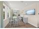 Bright dining area featuring a glass table, chairs, and a beverage center at 340 Avenida De Mayo, Sarasota, FL 34242