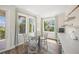 Charming dining area with a round glass table, seating, and a drink station with natural light at 340 Avenida De Mayo, Sarasota, FL 34242