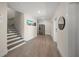 Hallway with a staircase, stainless steel refrigerator, wooden floors, and neutral paint at 340 Avenida De Mayo, Sarasota, FL 34242
