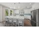 Bright kitchen features white cabinets, stainless steel appliances, a large island, and stylish pendant lighting at 340 Avenida De Mayo, Sarasota, FL 34242