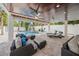 Relax in this covered outdoor living space near the pool with plush seating and ceiling fans at 340 Avenida De Mayo, Sarasota, FL 34242